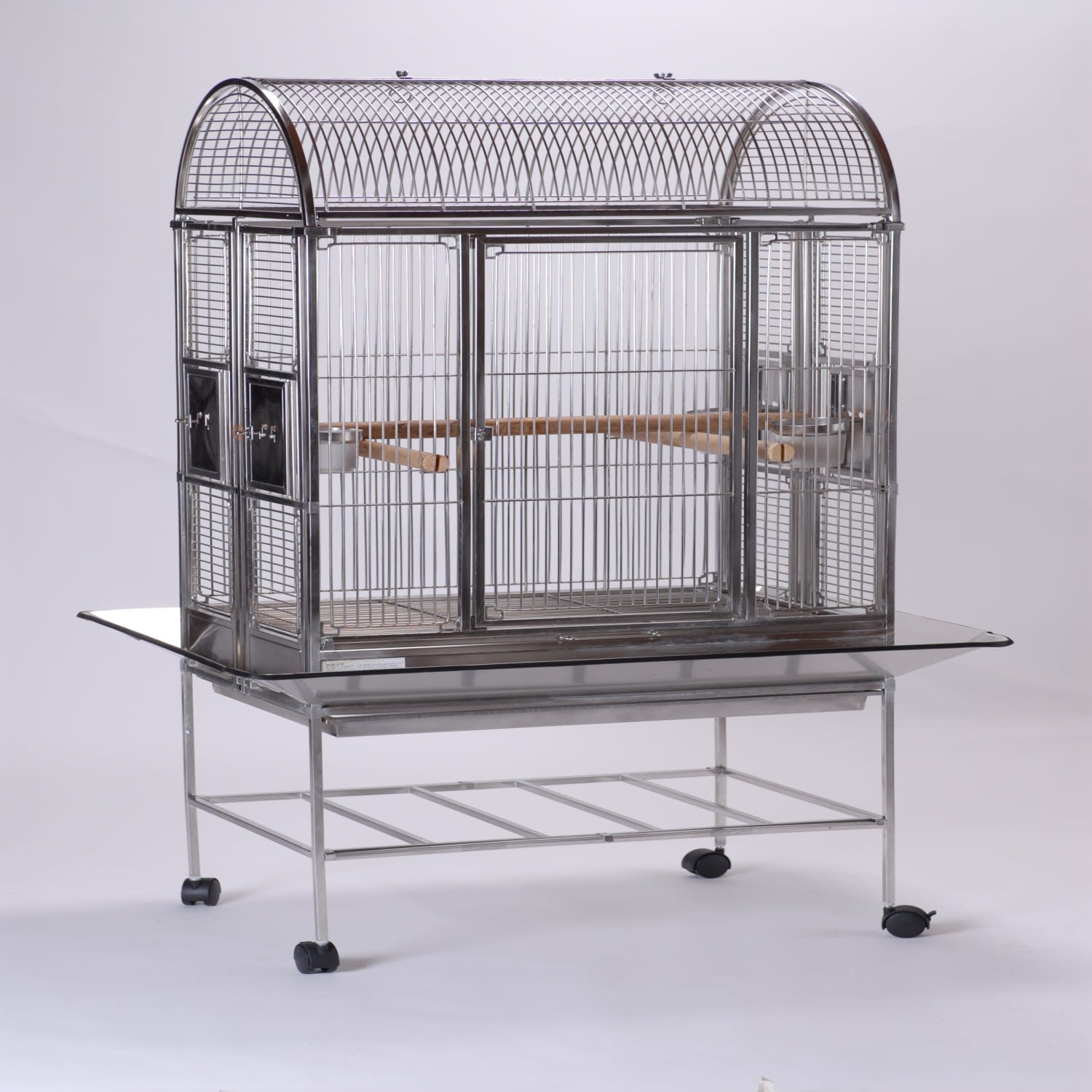 C20th brass and wirework stepped rectangular bird cage, with slide out  base, opaque glass feeder and